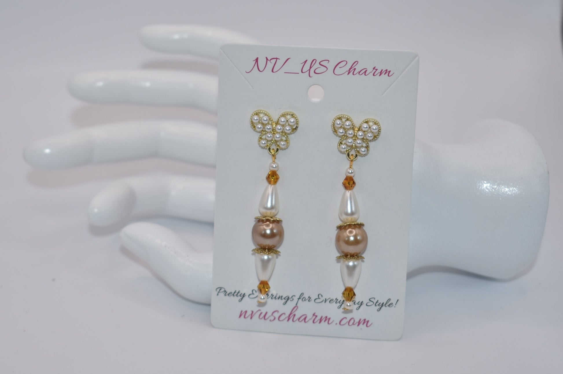 Add some whimsy to your wardrobe with our Brown Collection! These hypoallergenic earrings feature tiny pearl butterfly posts and a mix of pretty pearls and crystals hanging approximately 1 1/2 inches from your ear. Comfortable and stylish, these earrings are perfect for any occasion.