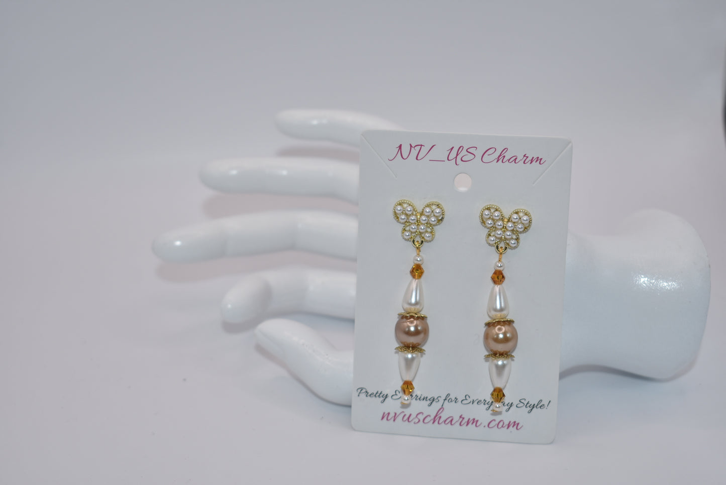 Add some whimsy to your wardrobe with our Brown Collection! These hypoallergenic earrings feature tiny pearl butterfly posts and a mix of pretty pearls and crystals hanging approximately 1 1/2 inches from your ear. Comfortable and stylish, these earrings are perfect for any occasion.