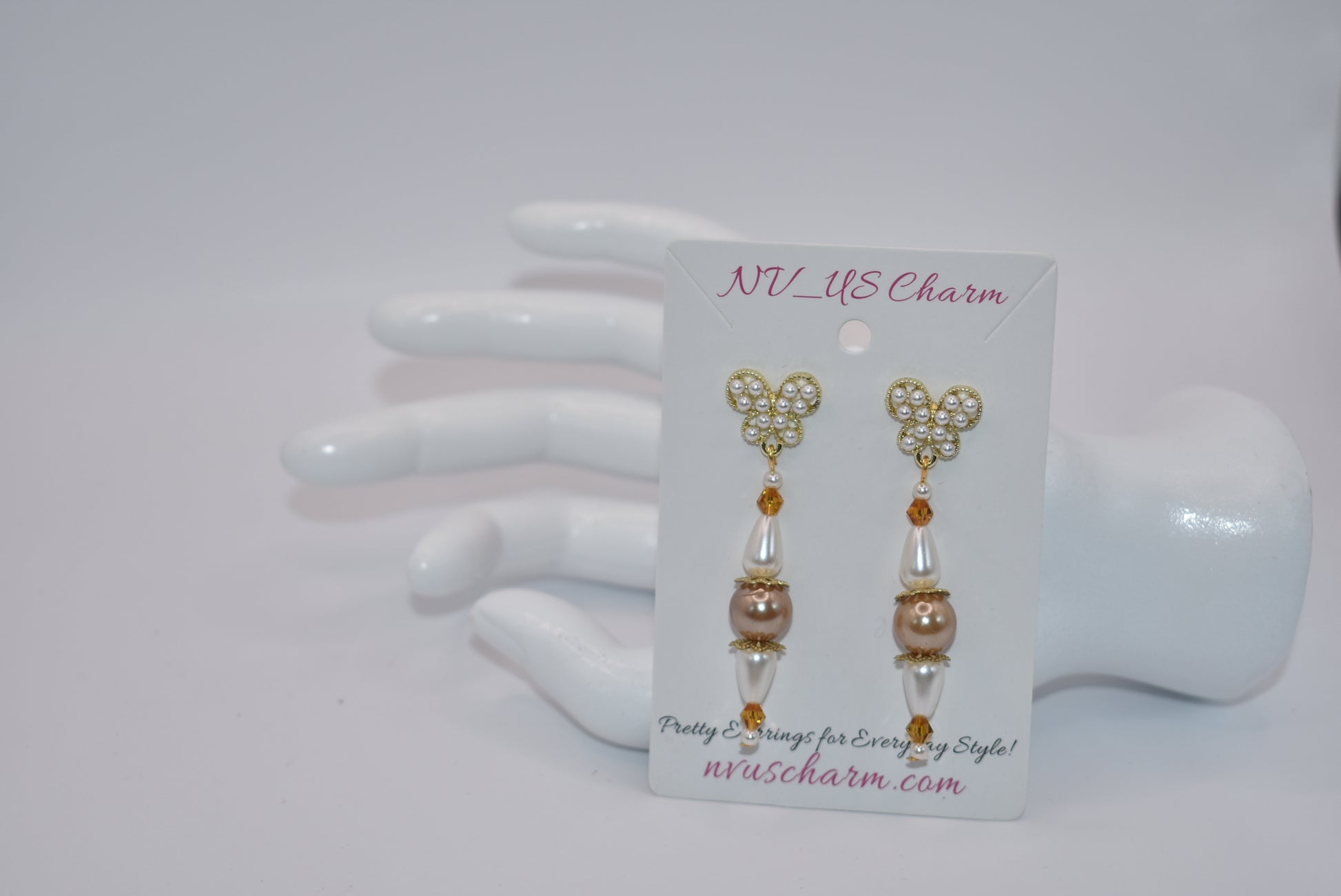 Add some whimsy to your wardrobe with our Brown Collection! These hypoallergenic earrings feature tiny pearl butterfly posts and a mix of pretty pearls and crystals hanging approximately 1 1/2 inches from your ear. Comfortable and stylish, these earrings are perfect for any occasion.