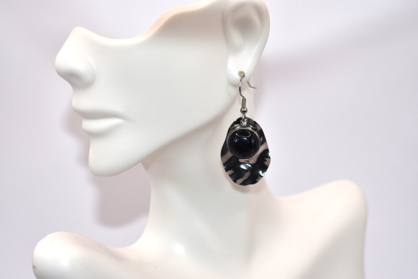 Add some playfulness to your collection with these gorgeous dark blue cabochon earrings. With a subtle sparkle and sturdy stainless-steel posts and backing, they are perfect for any occasion. Come check out these beauties!&nbsp; These earrings are hypoallergenic for sensitive ears.&nbsp;&nbsp;