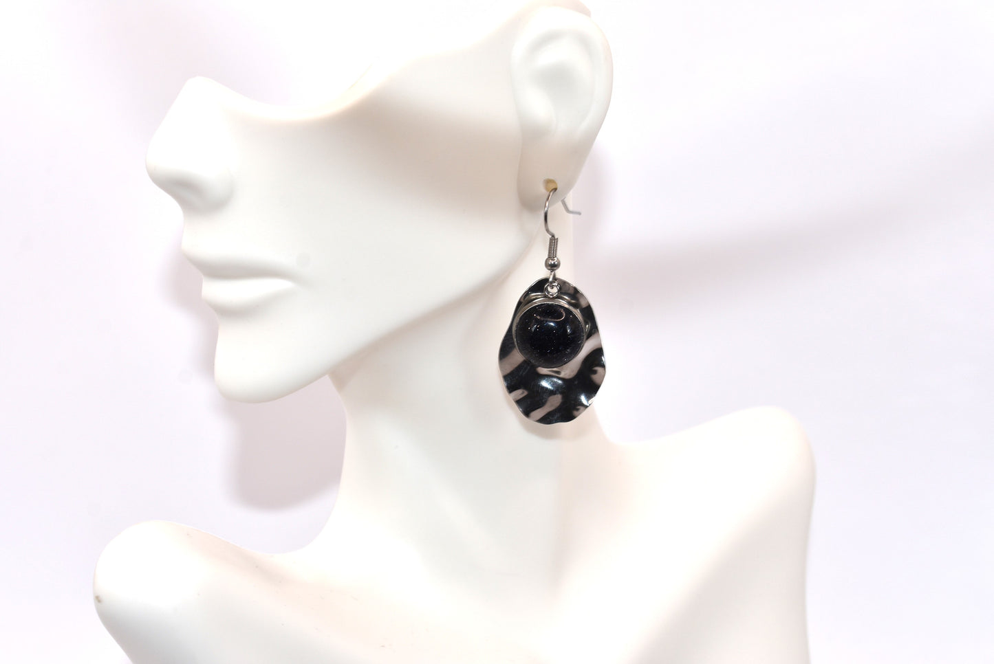 Add some playfulness to your collection with these gorgeous dark blue cabochon earrings. With a subtle sparkle and sturdy stainless-steel posts and backing, they are perfect for any occasion. Come check out these beauties!&nbsp; These earrings are hypoallergenic for sensitive ears.&nbsp;&nbsp;