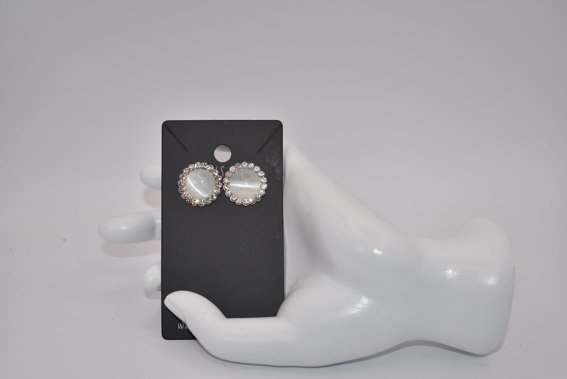 Introducing our White Collection! These unique earrings are a perfect addition to any outfit, featuring stunning white gems surrounded by sparkling white crystals. With a hypoallergenic post for comfort, they're perfect for anyone seeking something different.