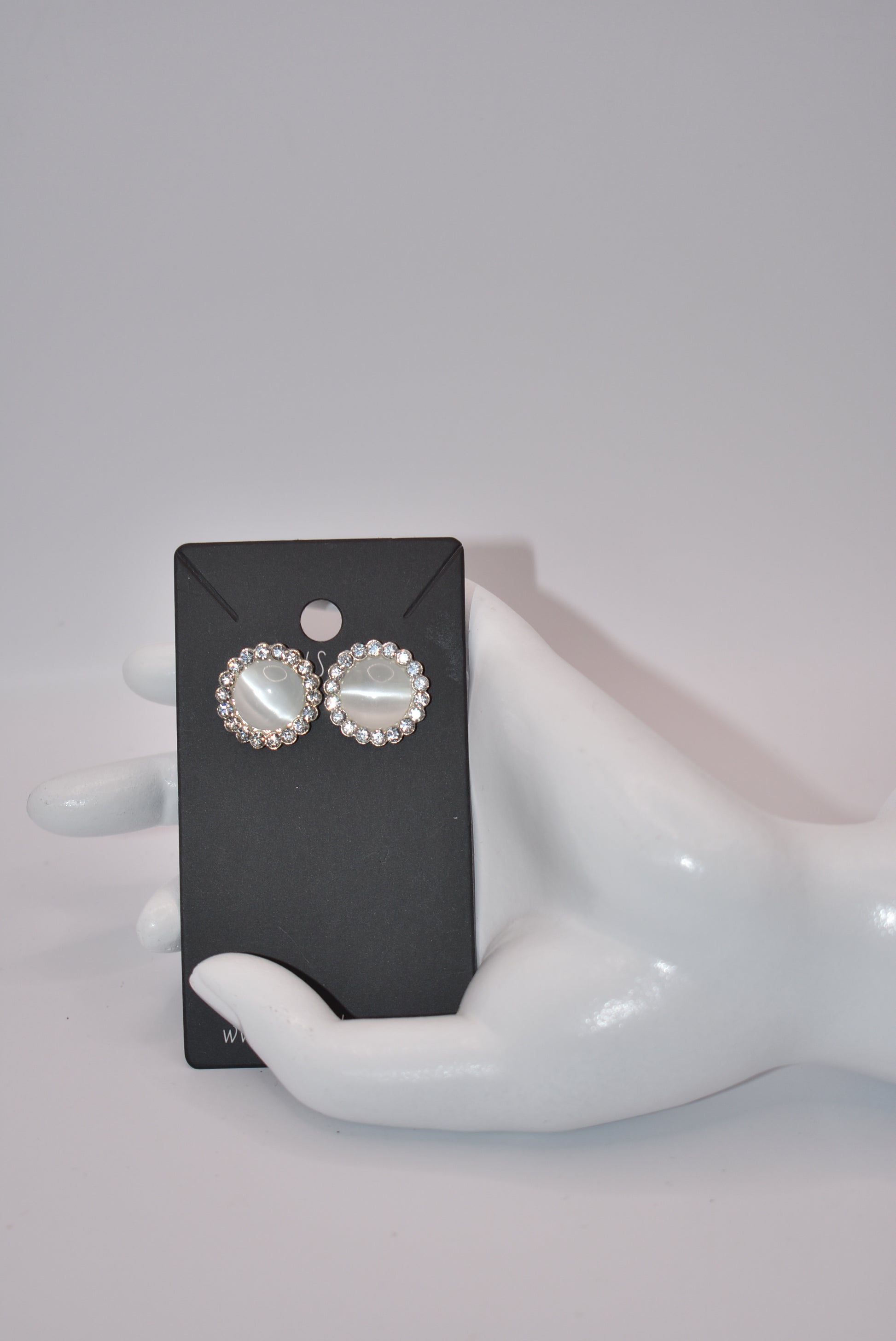 Introducing our White Collection! These unique earrings are a perfect addition to any outfit, featuring stunning white gems surrounded by sparkling white crystals. With a hypoallergenic post for comfort, they're perfect for anyone seeking something different.