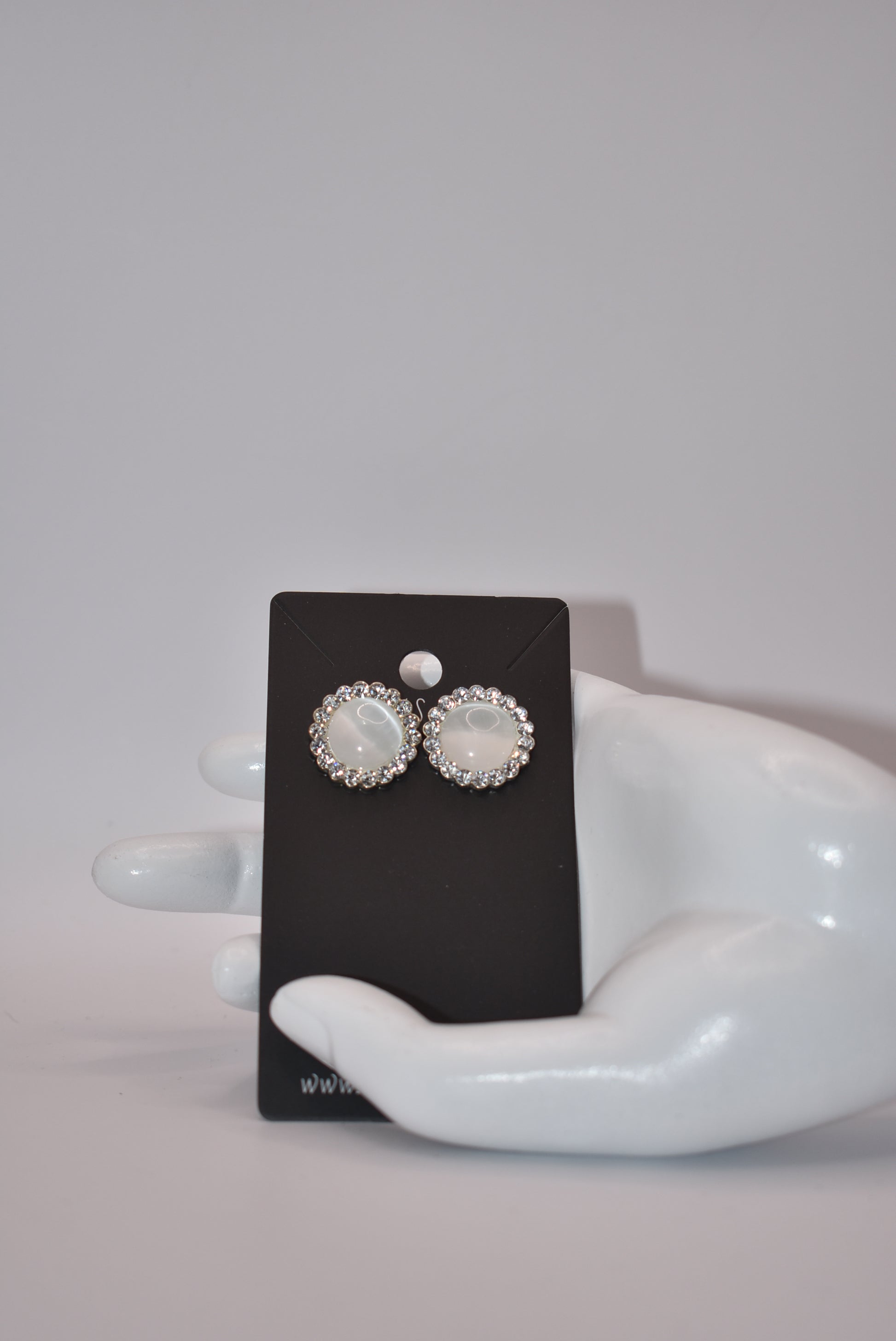 Introducing our White Collection! These unique earrings are a perfect addition to any outfit, featuring stunning white gems surrounded by sparkling white crystals. With a hypoallergenic post for comfort, they're perfect for anyone seeking something different.