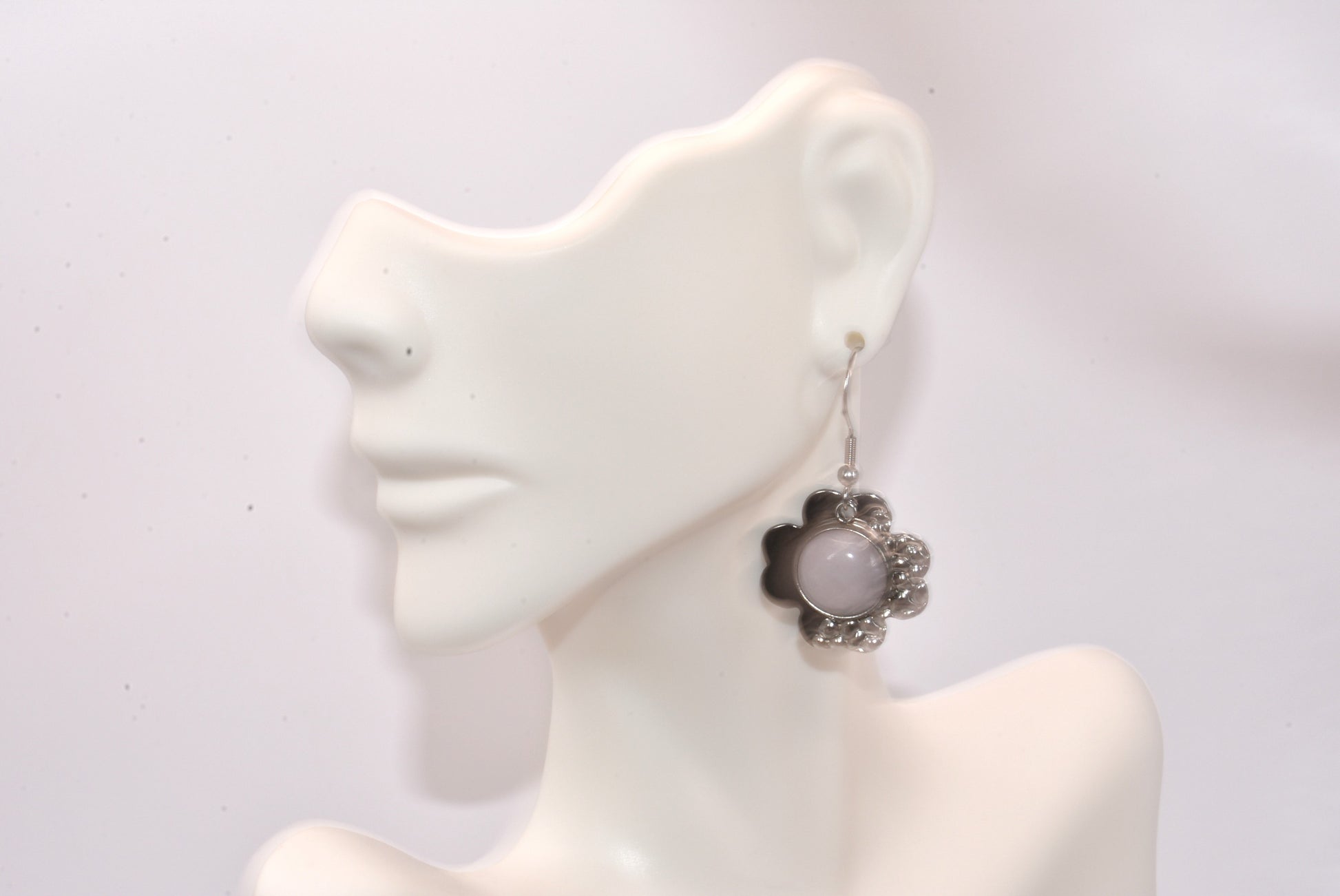 Add some flower power with White Collection 3! These hypoallergenic earrings feature a stainless-steel flower piece with white cabochon stones. Hanging from stainless steel posts, they're both comfortable and stylish. Don't miss out on this pretty pair!