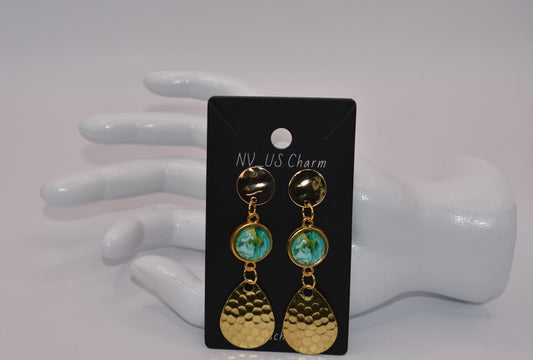 Add a touch of glamour to your outfit with our Gold Collection. These statement earrings feature hypoallergenic gold posts and a stunning green and gold cabochon center. The hanging gold spinner adds a unique twist, while the 2 1/2 inch drop will surely turn heads. Comfortable and stylish, these earrings are a must-have!