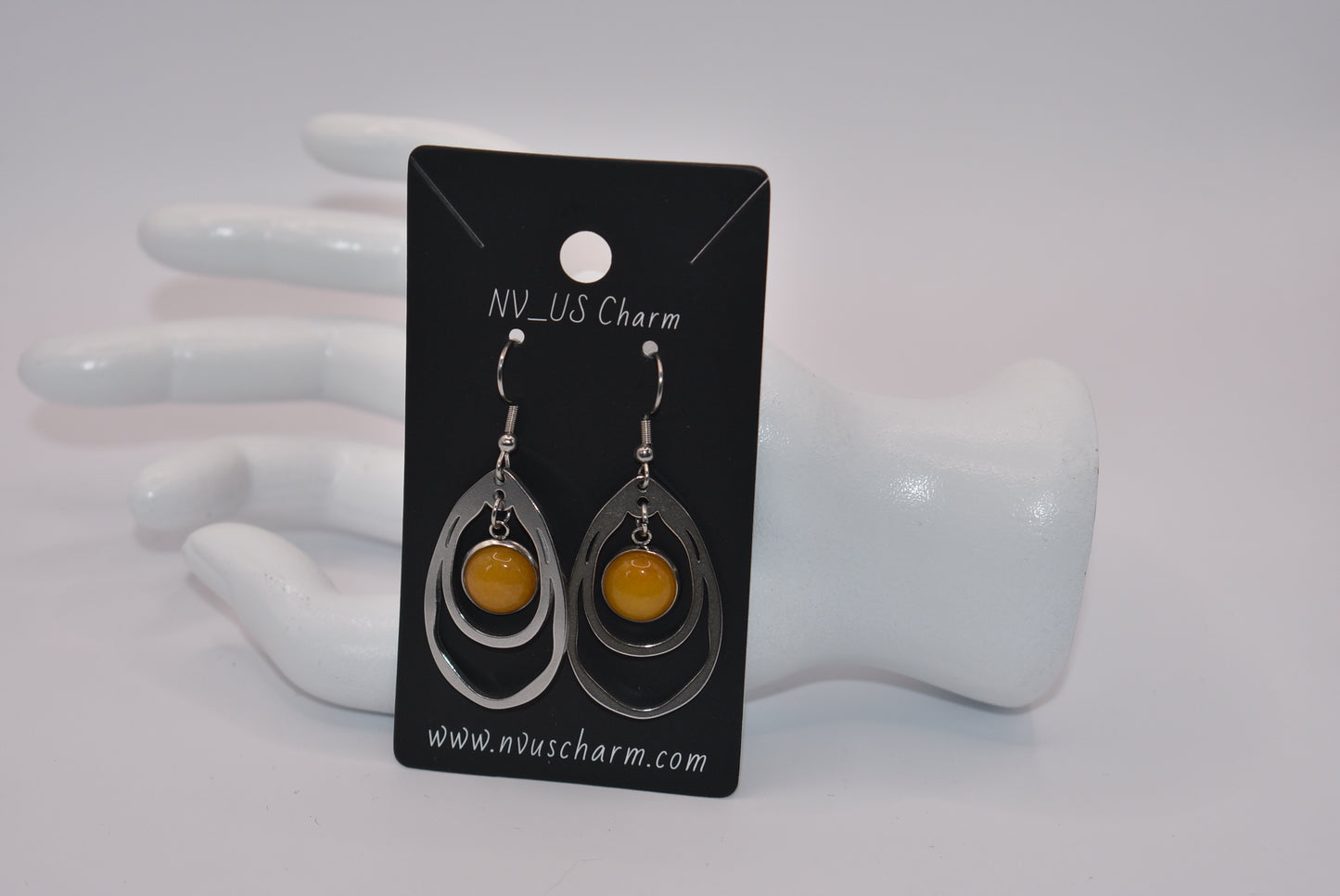 Add a touch of sunshine to your outfit with our Yellow Collection earrings. Made with hypoallergenic stainless-steel hooks, these beautiful hanging earrings feature a stunning cabochon stone in a bright and bold yellow hue. So comfortable and stylish, they'll make your look pop!