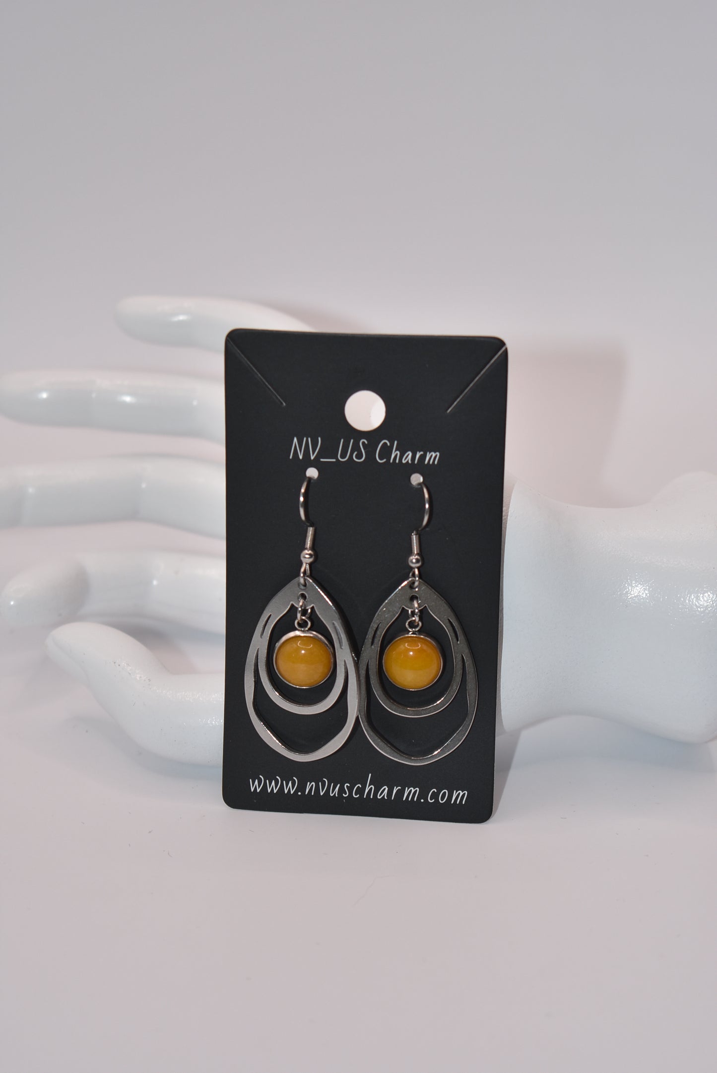 Add a touch of sunshine to your outfit with our Yellow Collection earrings. Made with hypoallergenic stainless-steel hooks, these beautiful hanging earrings feature a stunning cabochon stone in a bright and bold yellow hue. So comfortable and stylish, they'll make your look pop!