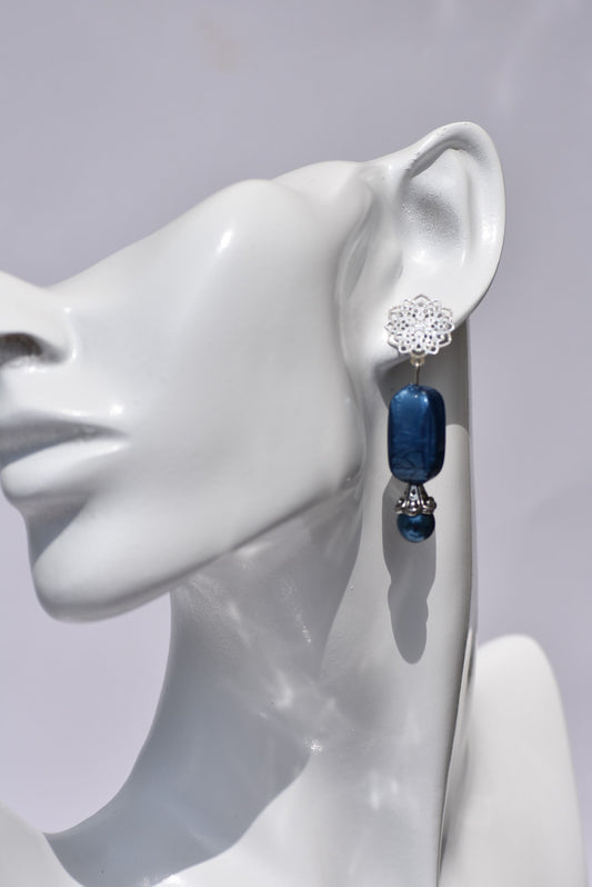 The Blue Collection 12 earrings are a unique and timeless piece crafted with beautiful sapphire blue pearl and beads, coupled with a silver filigree post. With their elegant and classic design, you'll be sure to turn heads.