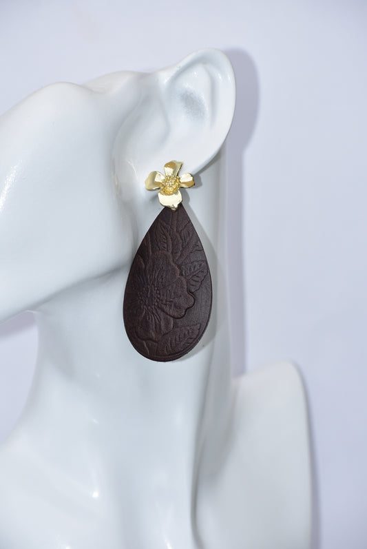 Experience the beauty of the Brown Collection. Crafted with dark brown flower-pressed faux leather in a unique teardrop shape. The elegant gold flower post earrings add a touch of glamour. Hypoallergenic and infused with Hawaiian flair, these earrings are perfect for any occasion.