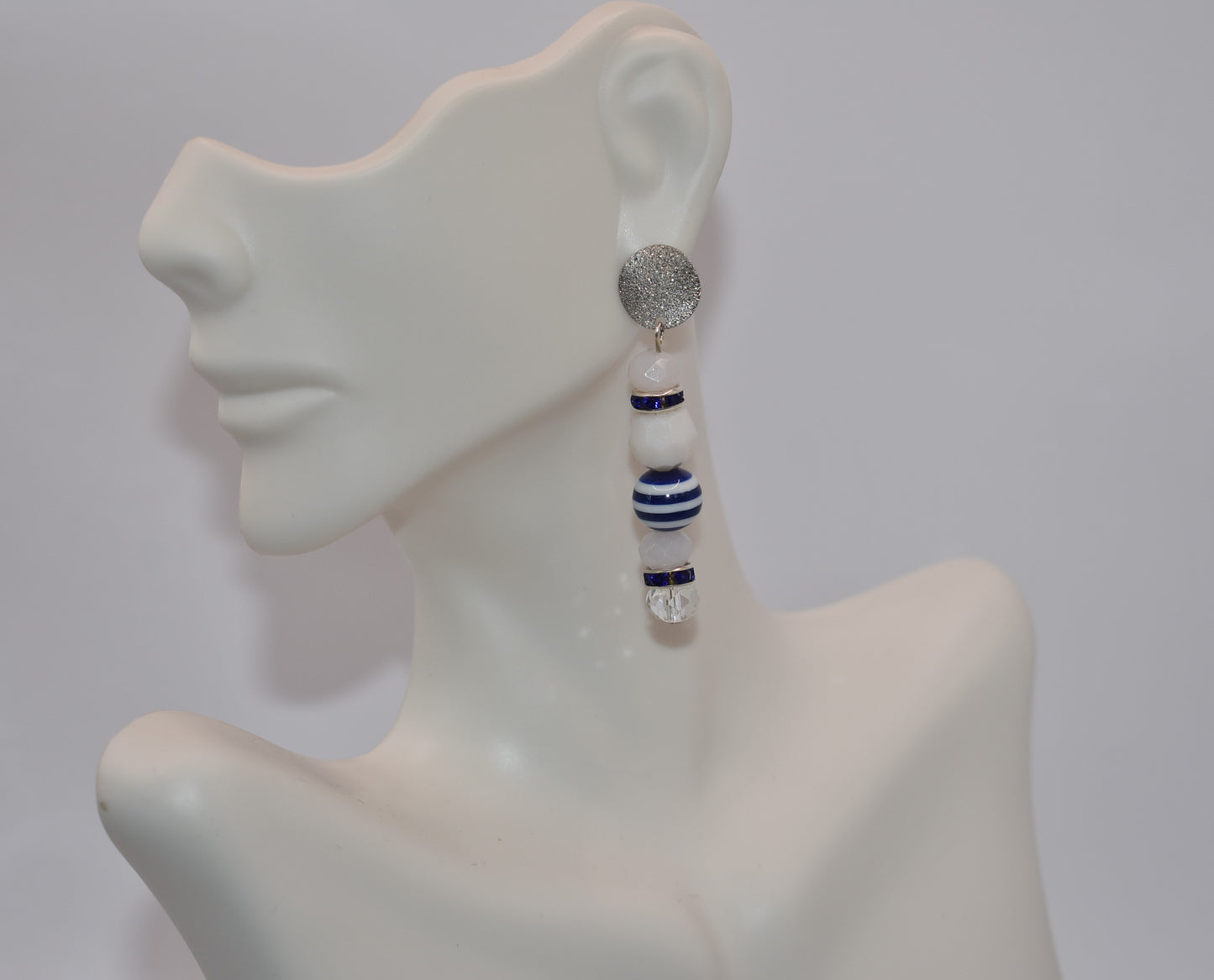 Step aboard and add a touch of sparkle to your nautical wardrobe with our one-of-a-kind Nautical Collection earrings. The silver, hypoallergenic, sparkly posts and mix of white and blue beads and crystals add a playful yet stylish touch to any outfit. "Sea" for yourself!