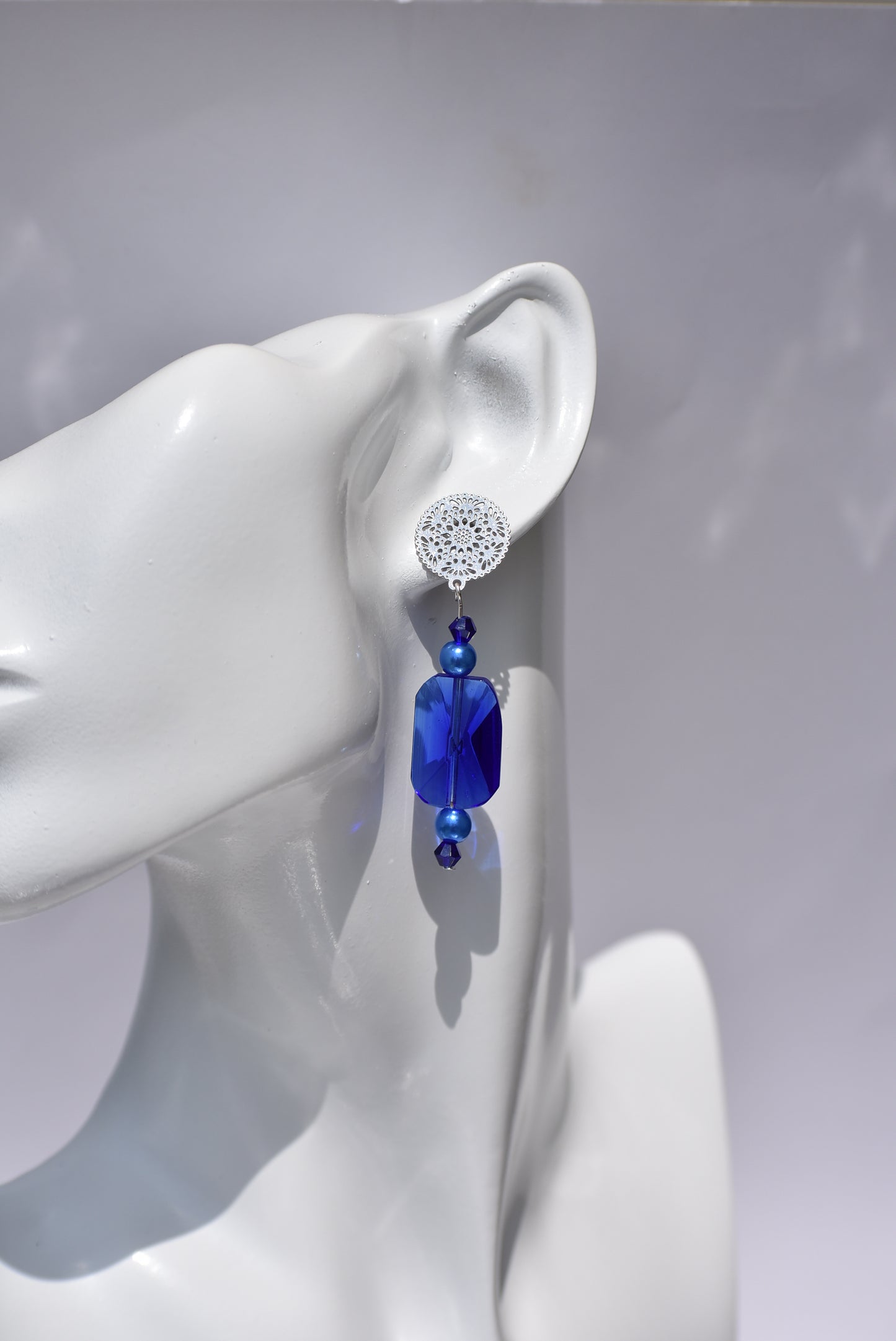 The Blue Collection 19 is perfect for any occasion. Its stunning cobalt blue crystals and blue pearls, set in silver filigree posts, offer a timeless and comfortable elegant look. Wear it and make a statement.