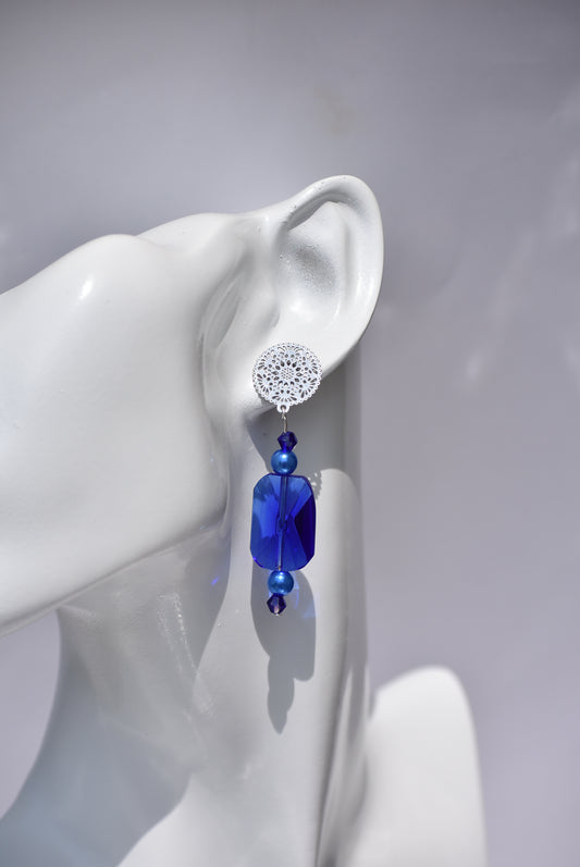 The Blue Collection 19 is perfect for any occasion. Its stunning cobalt blue crystals and blue pearls, set in silver filigree posts, offer a timeless and comfortable elegant look. Wear it and make a statement.