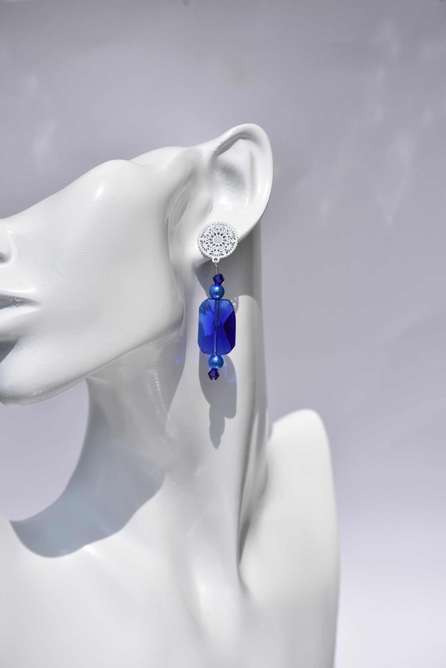 The Blue Collection 19 is perfect for any occasion. Its stunning cobalt blue crystals and blue pearls, set in silver filigree posts, offer a timeless and comfortable elegant look. Wear it and make a statement.