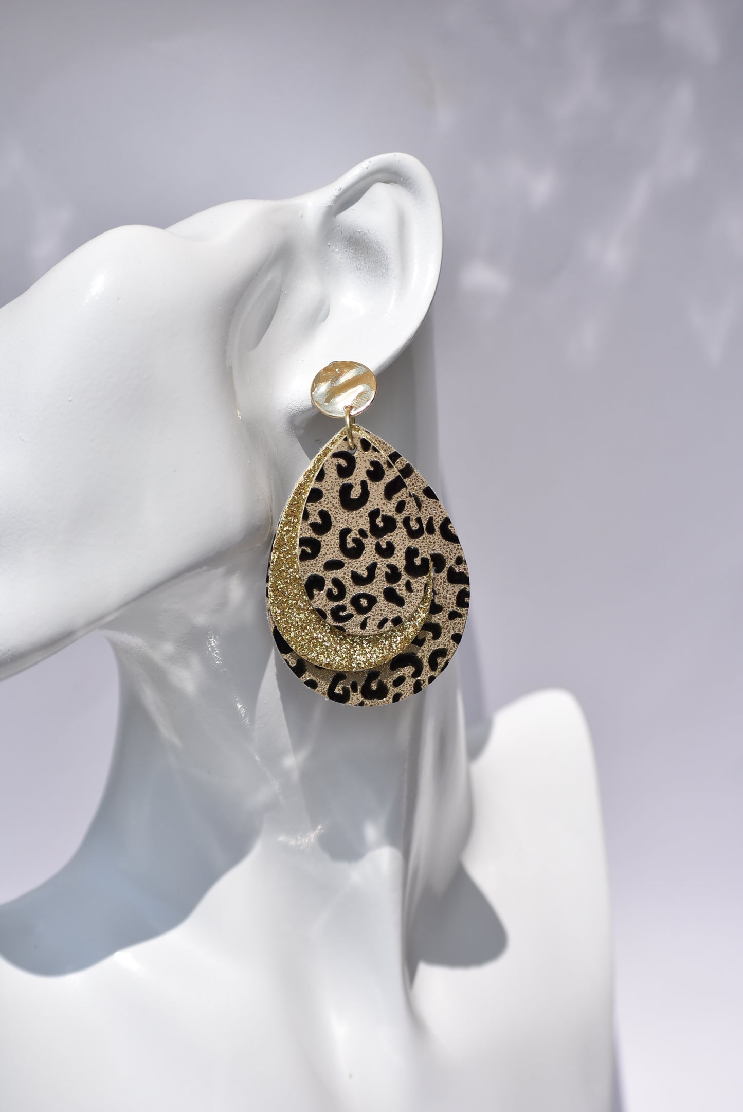 ﻿These gold stunners are sure to get attention.  Gold posts and gold glitter and leopard print teardrops bring these earrings to life.  You will be roaring in these.  