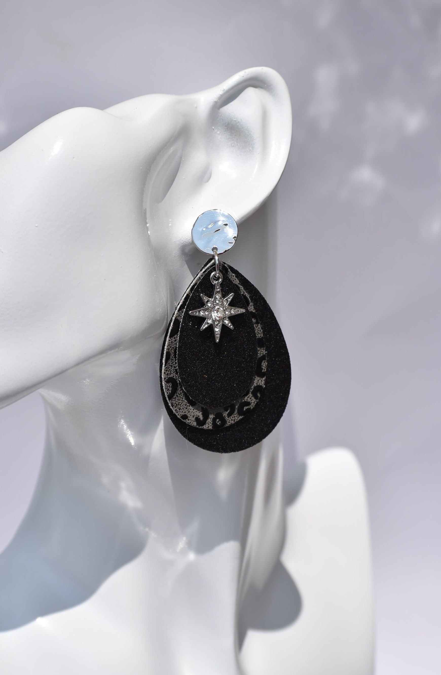 Black glitter teardrops hold a center leopard print in black and gray.  A pretty crystal star charm hangs from the top of these silver post earrings.  