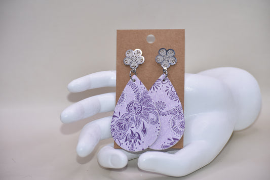 "Unleash your playful side with our Purple Collection earrings. The faux leather material comes in a unique pattern, while the silver filled filigree posts provide a secure fit. Hypoallergenic for all-day wear, so you can rock these beauties with ease!"