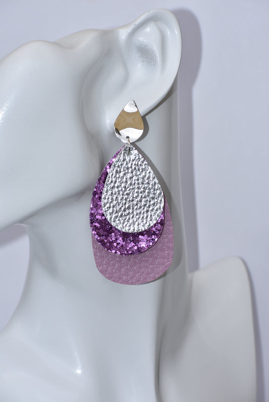 Add some sparkle to your outfit with the Purple Collection earrings! Featuring a layer of lavender faux leather, a middle layer of purple glitter, and topped with silver faux leather, these earrings will make you shine. With sturdy silver-plated teardrop posts, you can wear them confidently all day.