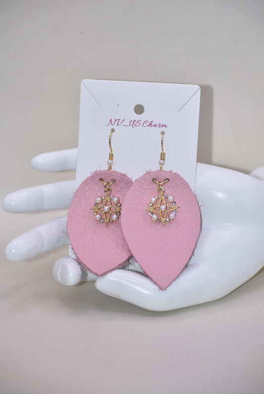 Make a statement with our Pink Collection! These adorable earrings feature pink soft faux leather teardrops and a pretty pearl charm, perfect for adding a touch of sweetness to any outfit. The hypoallergenic gold filled hooks make them suitable for even the most sensitive ears.