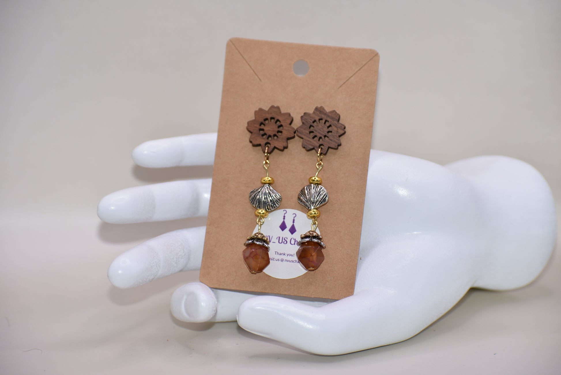 Get ready to make a statement with our Brown Collection! Featuring a one-of-a-kind piece with unique wood flowered post earrings and hanging seashell charms adorned with a pretty stone, this collection offers a great mix of brown, silver, and gold tones. Stand out with a touch of elegance and playfulness.