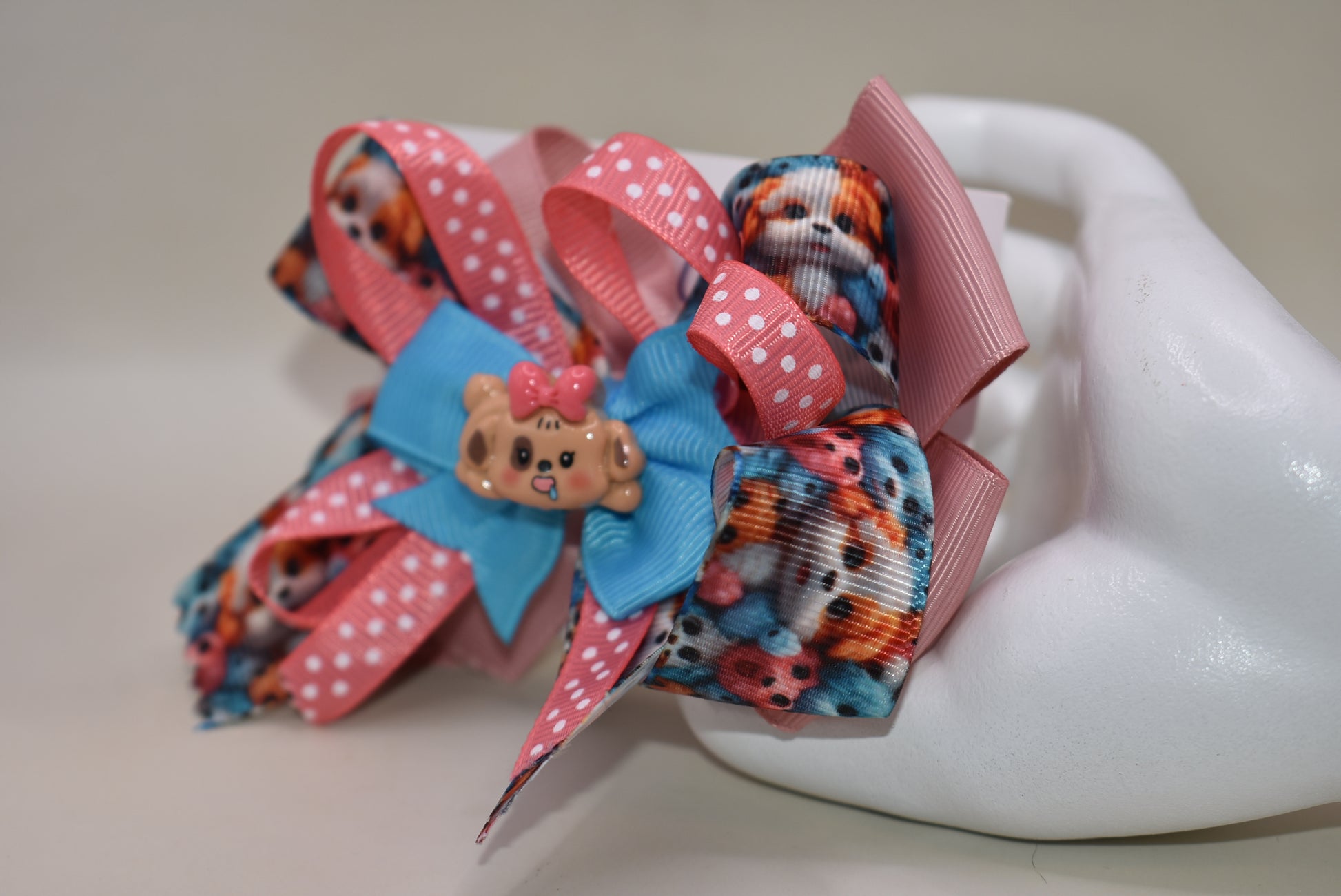 Add a splash of fun with this adorable dog charm from Nana's Collection! Featuring layers of a cute pup and a cheerful polka dot ribbon, it clips on easily with a wrapped alligator clip—perfect for quick, playful style. 🐶🎀 Clip it on and let the smiles begin!