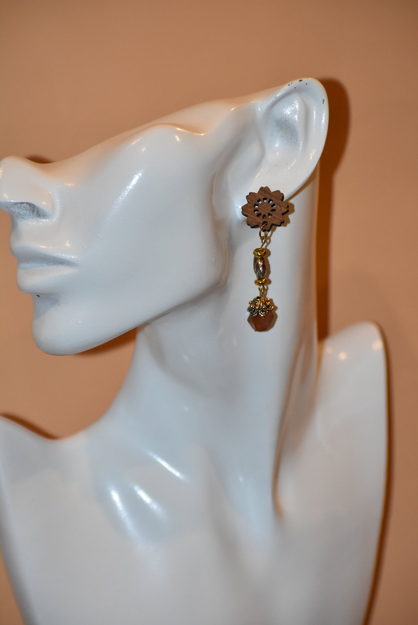 Get ready to make a statement with our Brown Collection! Featuring a one-of-a-kind piece with unique wood flowered post earrings and hanging seashell charms adorned with a pretty stone, this collection offers a great mix of brown, silver, and gold tones. Stand out with a touch of elegance and playfulness.