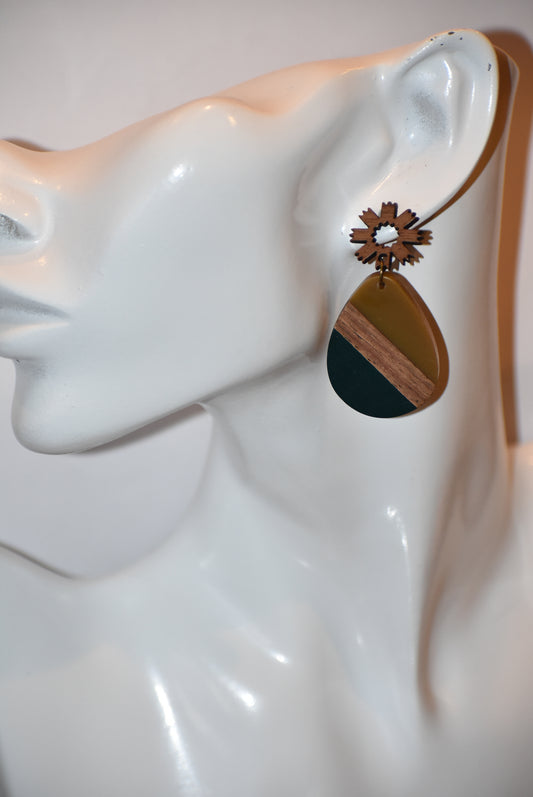 Add a pop of color to your outfit with our Green Collection earrings! The playful flowered wood posts hold a gorgeous teardrop shaped pendant made of wood and green resin. These earrings add both style and comfort to your wardrobe.