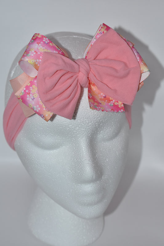 Wrap your hair in sweetness with this charming headband! 🎀 Featuring delicate layers of ribbon and soft nylon, it's designed for all-day comfort without the fuss. The pretty pink hue and cheerful floral pattern add a fun, feminine touch to any outfit. 🌸 Whether you're heading to brunch or running errands, this wrapped beauty keeps your style on point while keeping strands in place. Perfect for anyone who loves a pop of color and playful elegance! ✨
