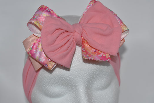 Wrap your hair in sweetness with this charming headband! 🎀 Featuring delicate layers of ribbon and soft nylon, it's designed for all-day comfort without the fuss. The pretty pink hue and cheerful floral pattern add a fun, feminine touch to any outfit. 🌸 Whether you're heading to brunch or running errands, this wrapped beauty keeps your style on point while keeping strands in place. Perfect for anyone who loves a pop of color and playful elegance! ✨
