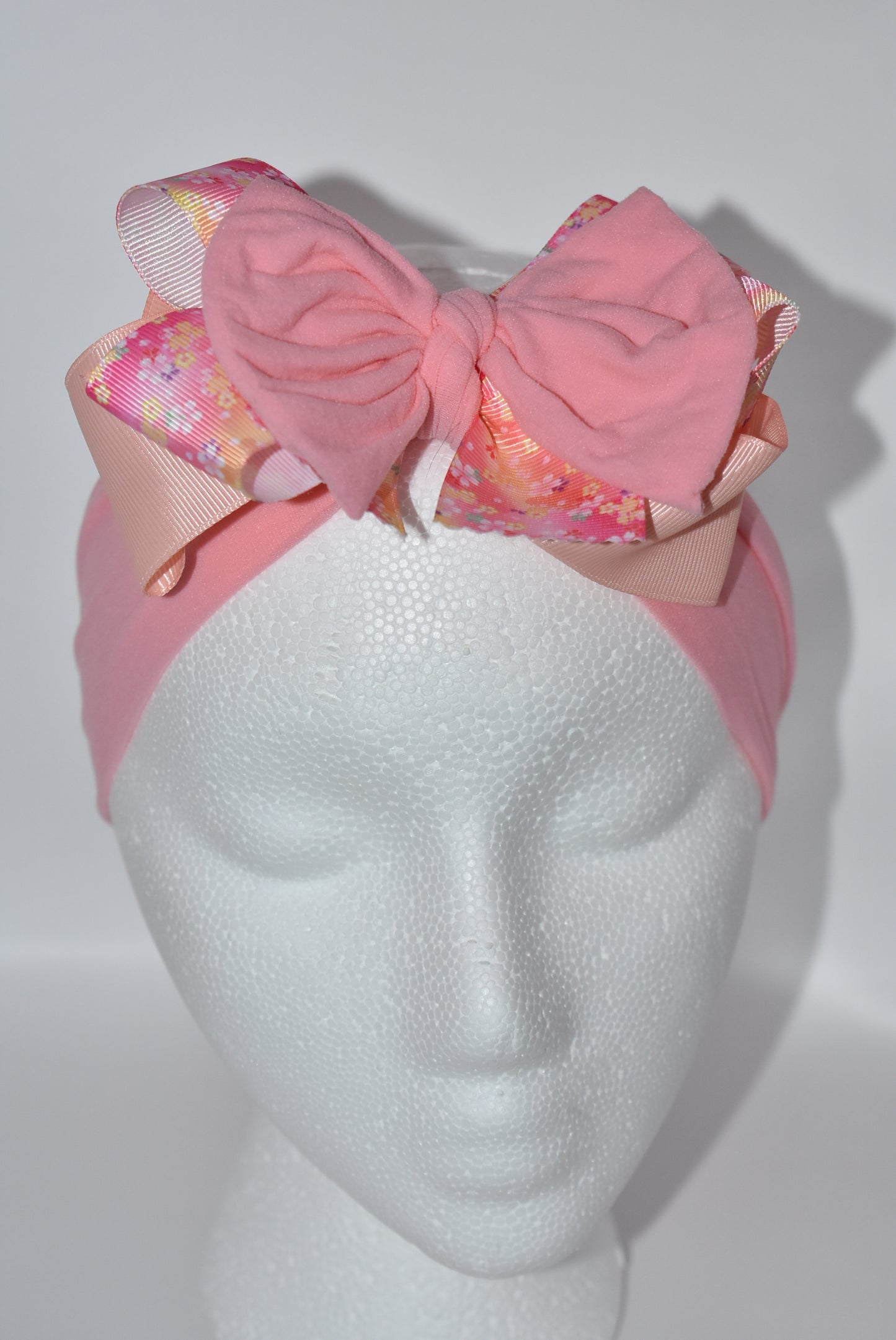 Wrap your hair in sweetness with this charming headband! 🎀 Featuring delicate layers of ribbon and soft nylon, it's designed for all-day comfort without the fuss. The pretty pink hue and cheerful floral pattern add a fun, feminine touch to any outfit. 🌸 Whether you're heading to brunch or running errands, this wrapped beauty keeps your style on point while keeping strands in place. Perfect for anyone who loves a pop of color and playful elegance! ✨
