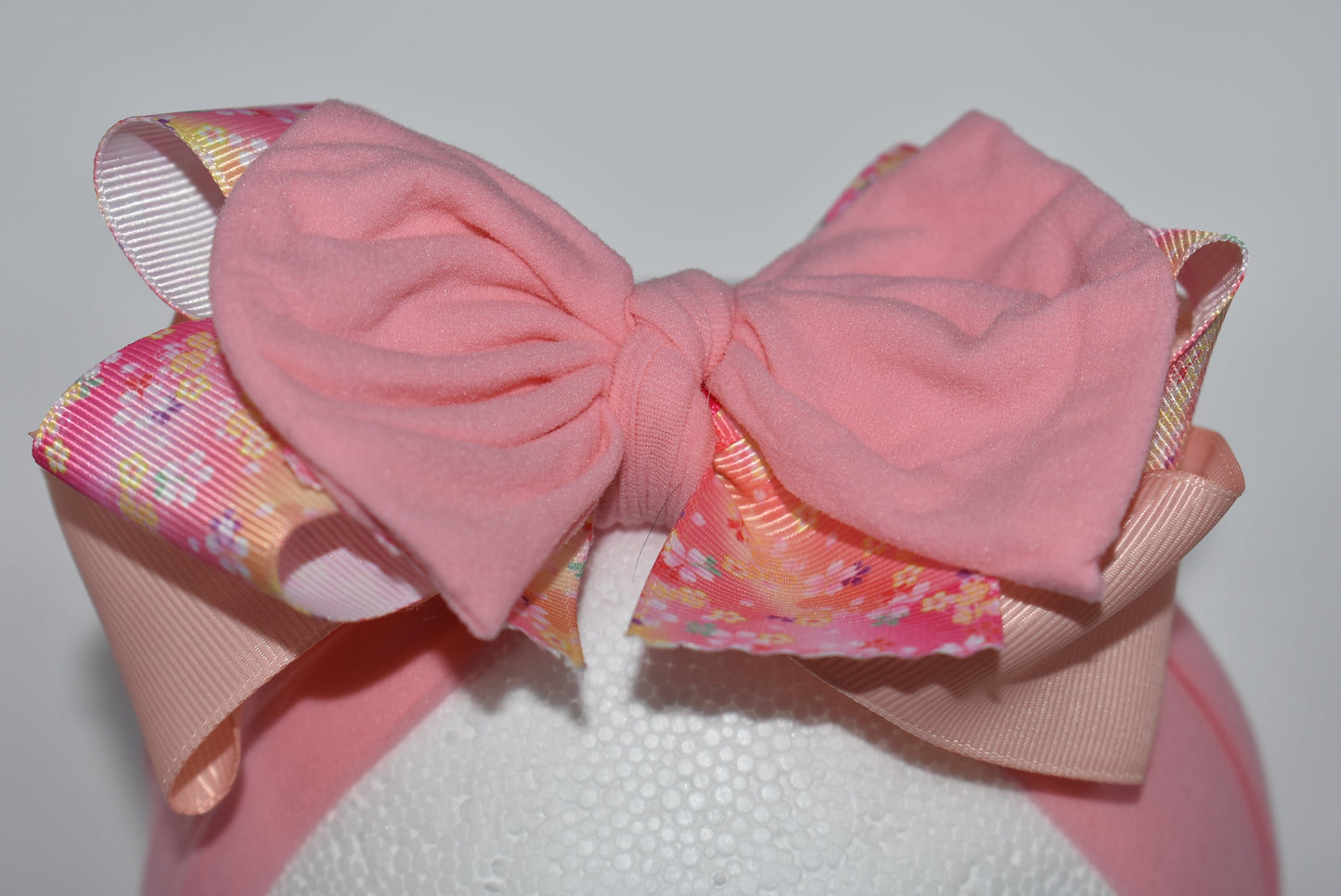 Wrap your hair in sweetness with this charming headband! 🎀 Featuring delicate layers of ribbon and soft nylon, it's designed for all-day comfort without the fuss. The pretty pink hue and cheerful floral pattern add a fun, feminine touch to any outfit. 🌸 Whether you're heading to brunch or running errands, this wrapped beauty keeps your style on point while keeping strands in place. Perfect for anyone who loves a pop of color and playful elegance! ✨