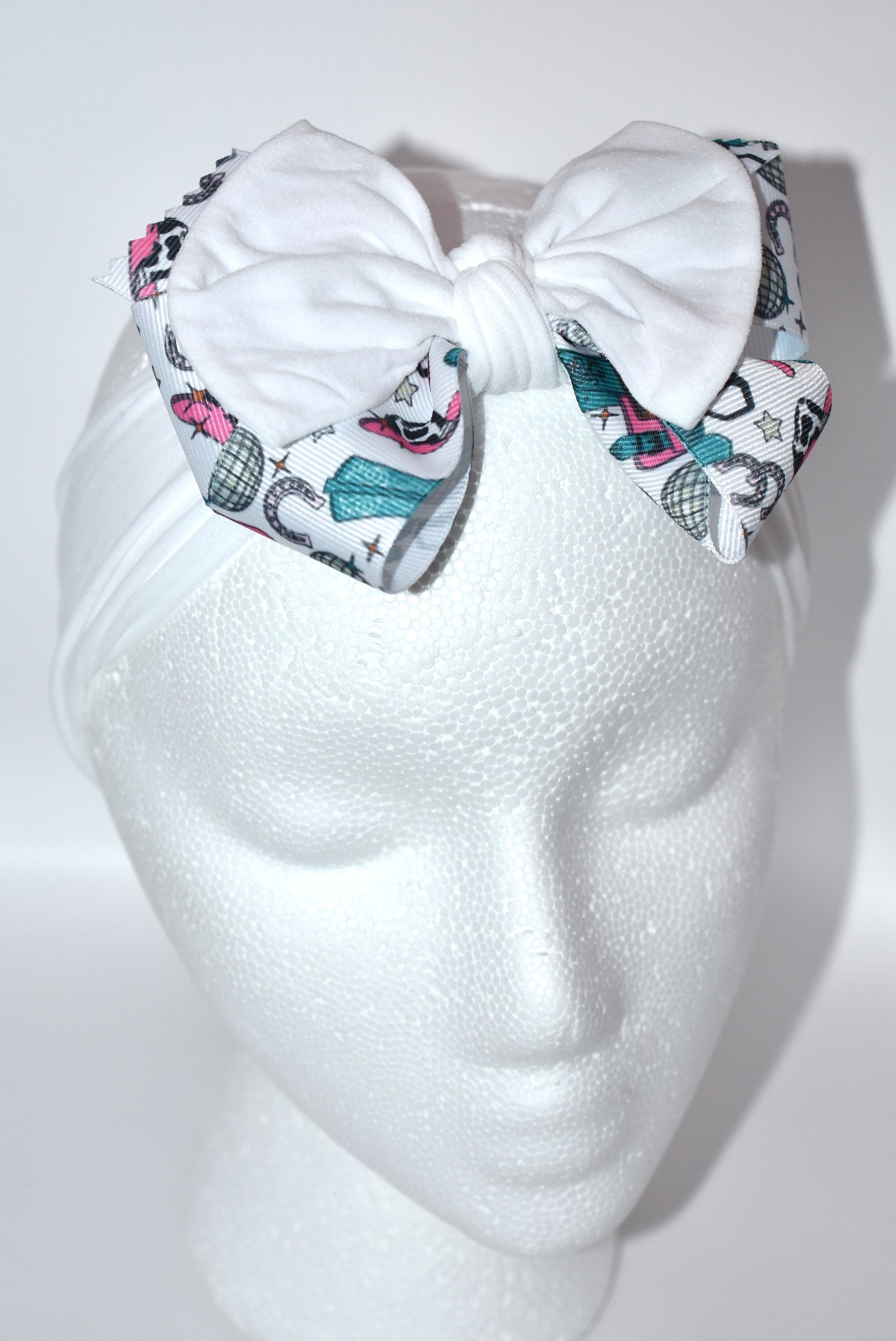 Get ready to ride in style with this pretty white wide headband! Featuring a soft fabric and a charming cowgirl bow in the center, it’s comfortable and perfect for cowgirls of all ages. Add a fun and unique touch to any outfit—giddy up! 🤠🎀💖