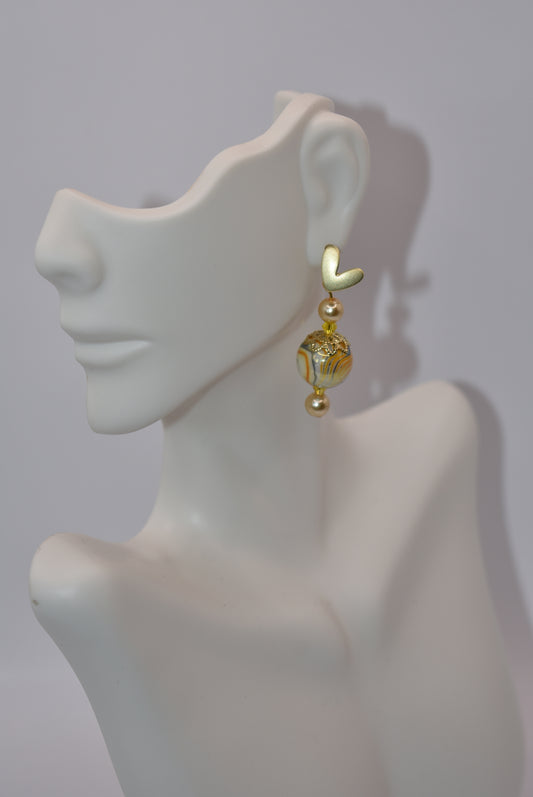 Dress your ears up (or down) with these stunning Pretty Yellow Collection earrings. The heart-shaped gold posts hold a beautiful array of yellow pearls, tiny crystals and beading, sure to catch some attention! Plus, they're hypoallergenic for sensitive ears.