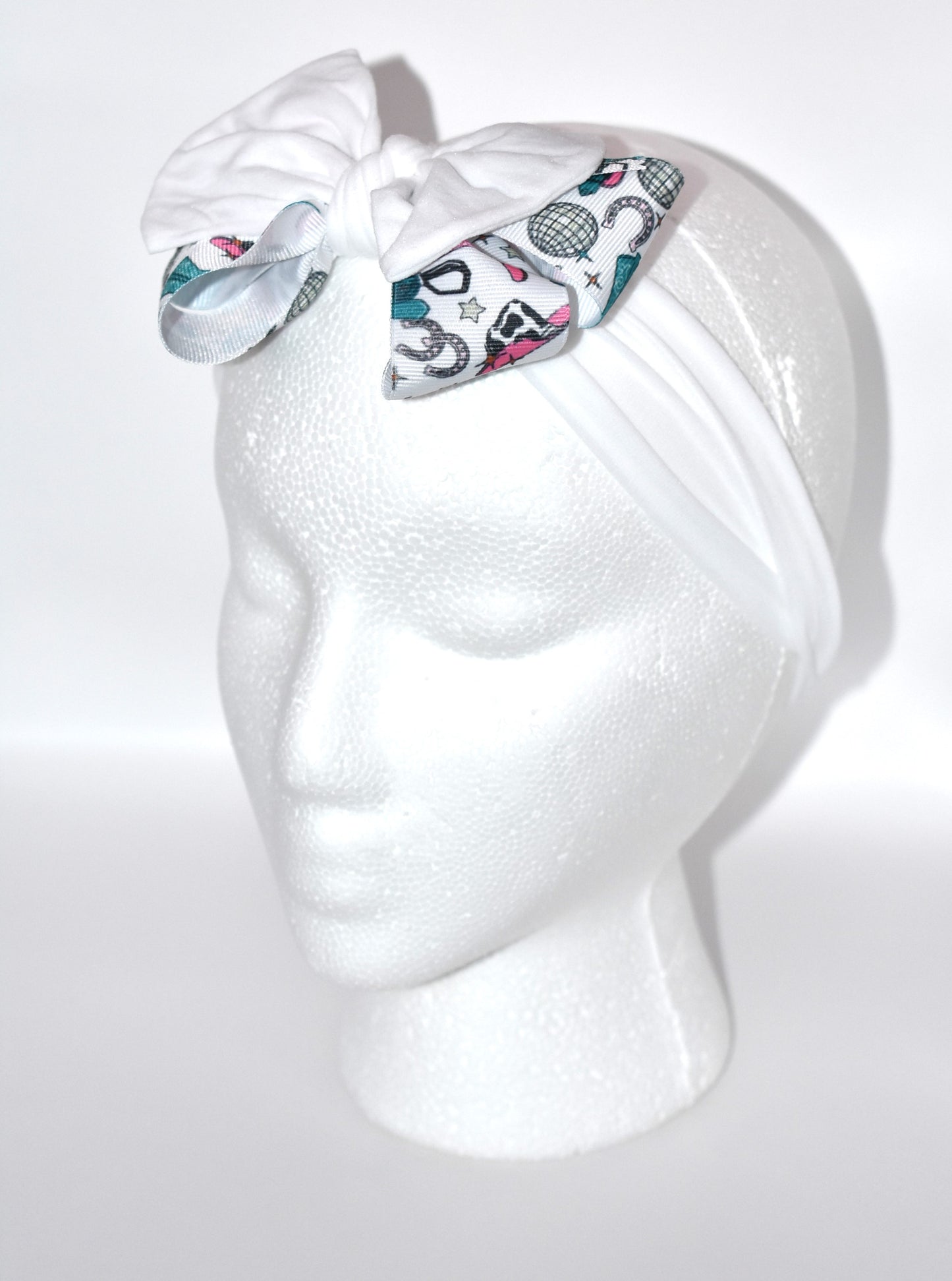 Get ready to ride in style with this pretty white wide headband! Featuring a soft fabric and a charming cowgirl bow in the center, it’s comfortable and perfect for cowgirls of all ages. Add a fun and unique touch to any outfit—giddy up! 🤠🎀💖