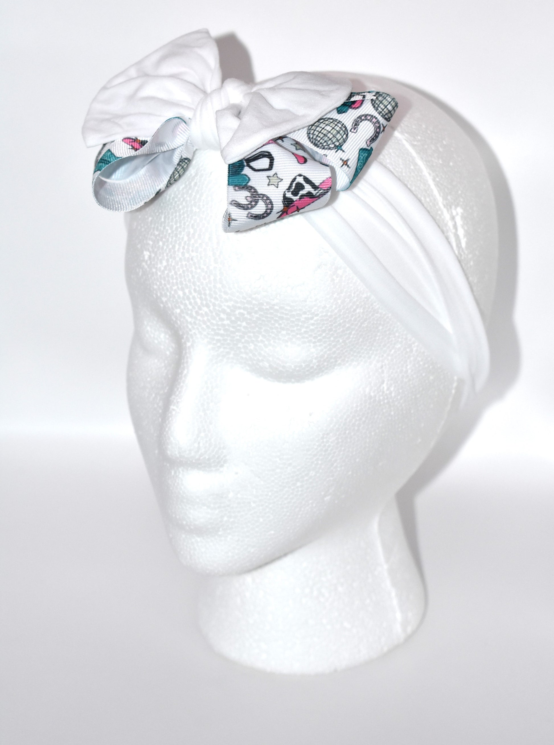 Get ready to ride in style with this pretty white wide headband! Featuring a soft fabric and a charming cowgirl bow in the center, it’s comfortable and perfect for cowgirls of all ages. Add a fun and unique touch to any outfit—giddy up! 🤠🎀💖