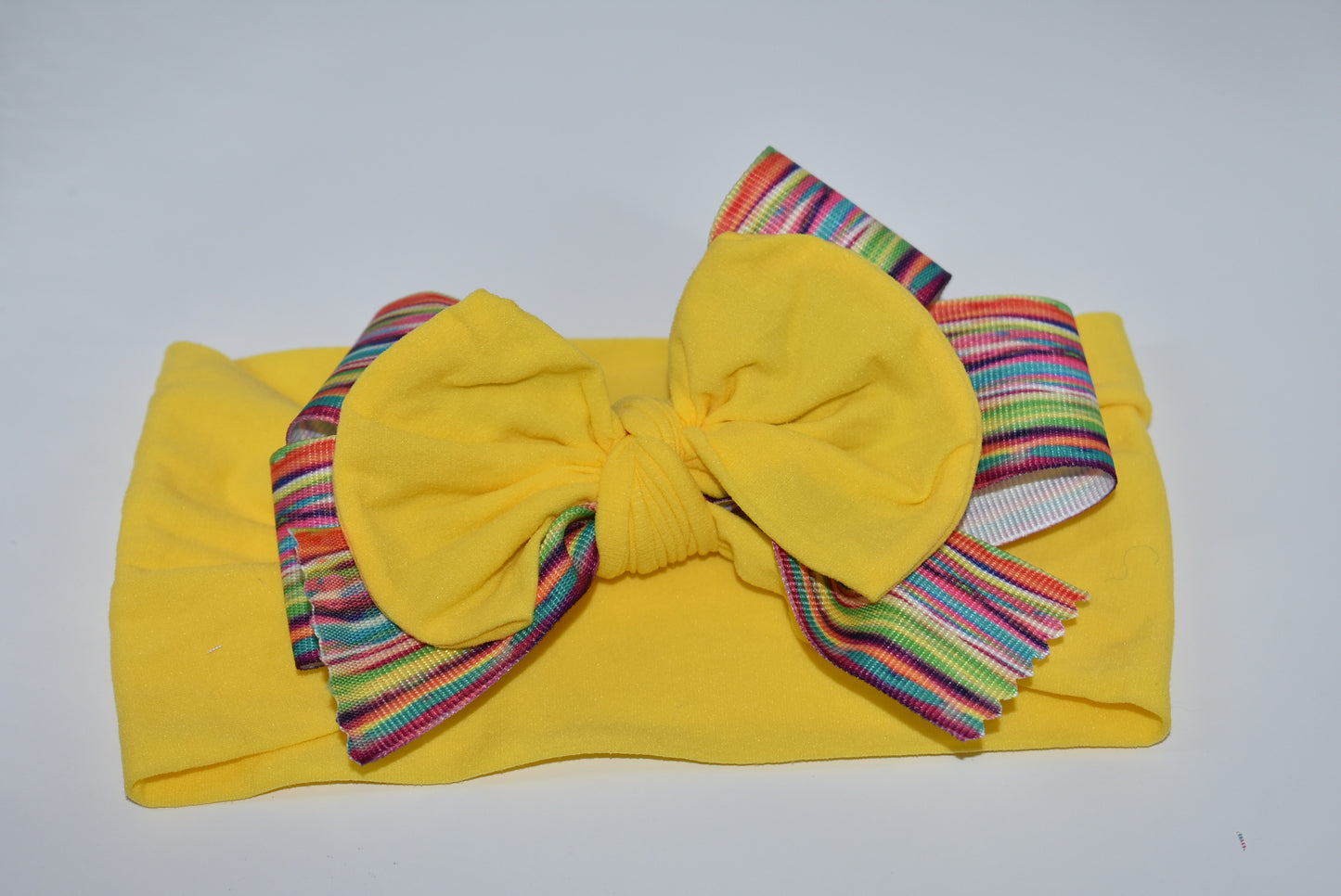 Add a pop of color and fun to any outfit with this wide, soft headband! Bright and pretty, it’s designed to brighten your day and perfectly suits all ages. Featuring a one-of-a-kind pattern, this headband is your go-to for stylish comfort all day long. 🌈✨🎀