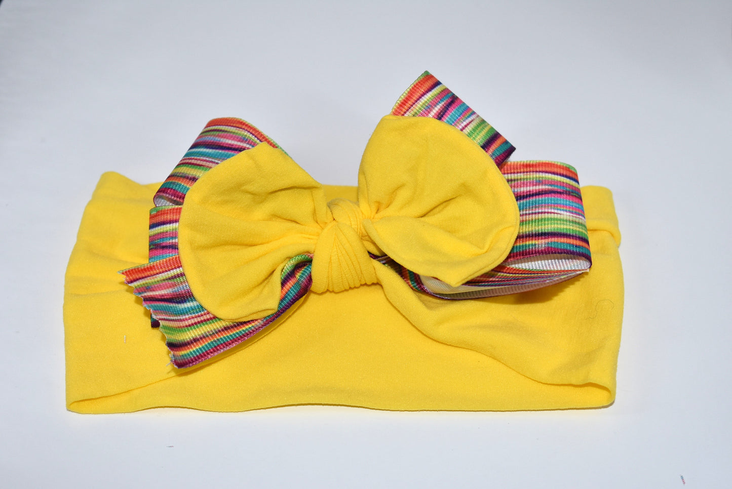 Add a pop of color and fun to any outfit with this wide, soft headband! Bright and pretty, it’s designed to brighten your day and perfectly suits all ages. Featuring a one-of-a-kind pattern, this headband is your go-to for stylish comfort all day long. 🌈✨🎀