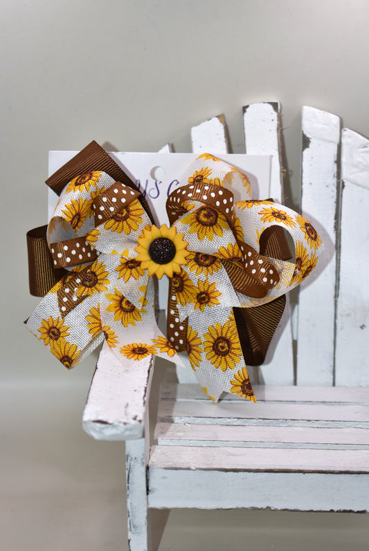 Brighten your little cutie’s day with Nana's Collection 176! This playful sunflower bow features a sunny yellow and brown combo with an adorable sunflower charm on top. The wrapped alligator clip ensures comfy, secure wear all day long. A perfect pop of sunshine for any little outfit! 🌻💛✨