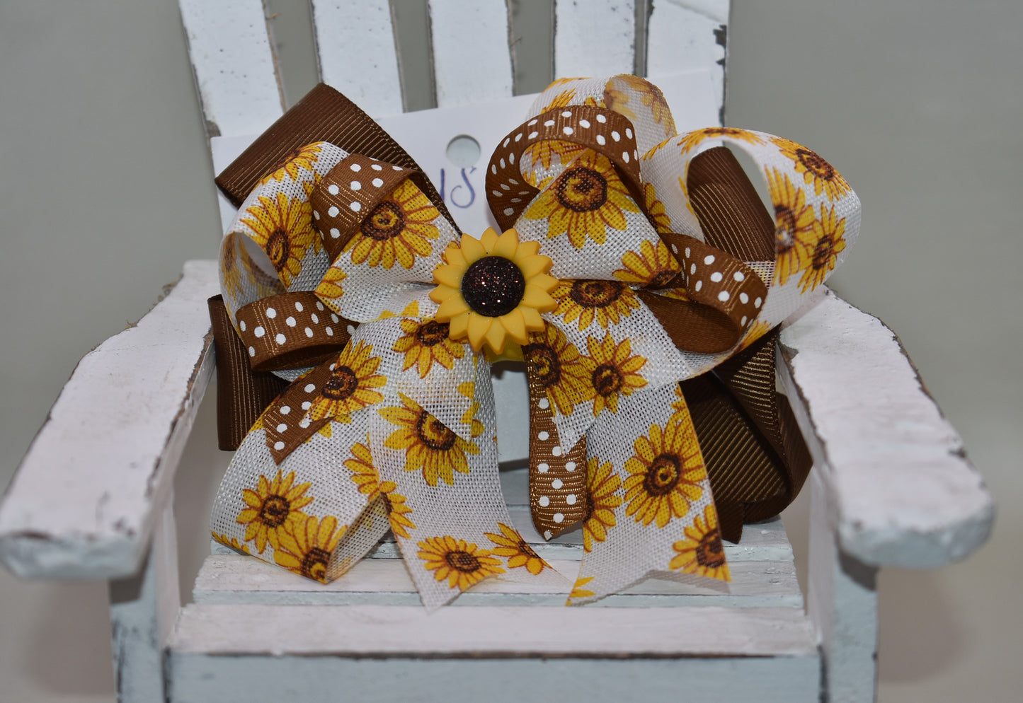 Brighten your little cutie’s day with Nana's Collection 176! This playful sunflower bow features a sunny yellow and brown combo with an adorable sunflower charm on top. The wrapped alligator clip ensures comfy, secure wear all day long. A perfect pop of sunshine for any little outfit! 🌻💛✨