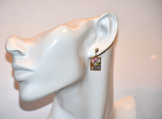 Rock the perfect look with our Pink Collection earrings! Featuring gold hypoallergenic posts and a colorful square crystal embellished front, these earrings are perfect for any outfit. Shiny and super cute on the ear, you'll be sure to turn heads.