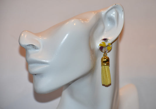 Add some sunny vibes to your look with our Yellow Collection! These super fun earrings feature pretty light-yellow tassels hanging from 16mm circle disc studs, speckled with yellow, purple and blue inside. Not only are they stylish on the ear, but they are also super comfortable to wear. Get ready to turn heads and brighten up any outfit!