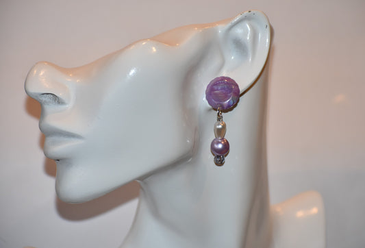 Add a pop of color to any outfit with our Purple Collection earrings. The lavender color is playful and the hanging pearls and crystals add a touch of elegance. Versatile enough for dressy or casual occasions, these unique earrings are sure to become a favorite.