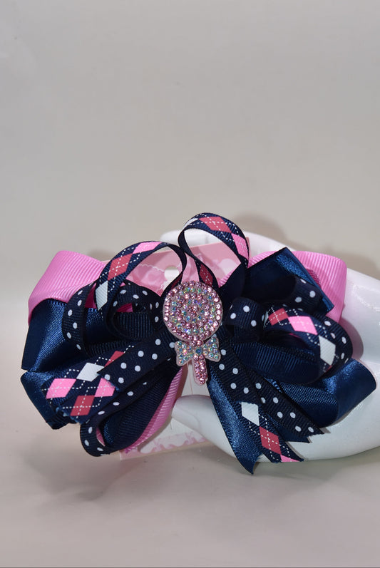 Add a pop of fun with this playful bow from Nana's Collection! Layers of pretty blue and pink ribbons create a charming swirl topped with a sparkling candy embellishment that’s sure to catch the eye 🍬✨. Perfect for adding a little extra sparkle to any outfit, it stays put all day thanks to a handy wrapped alligator clip. Sweet style made easy! 🎀