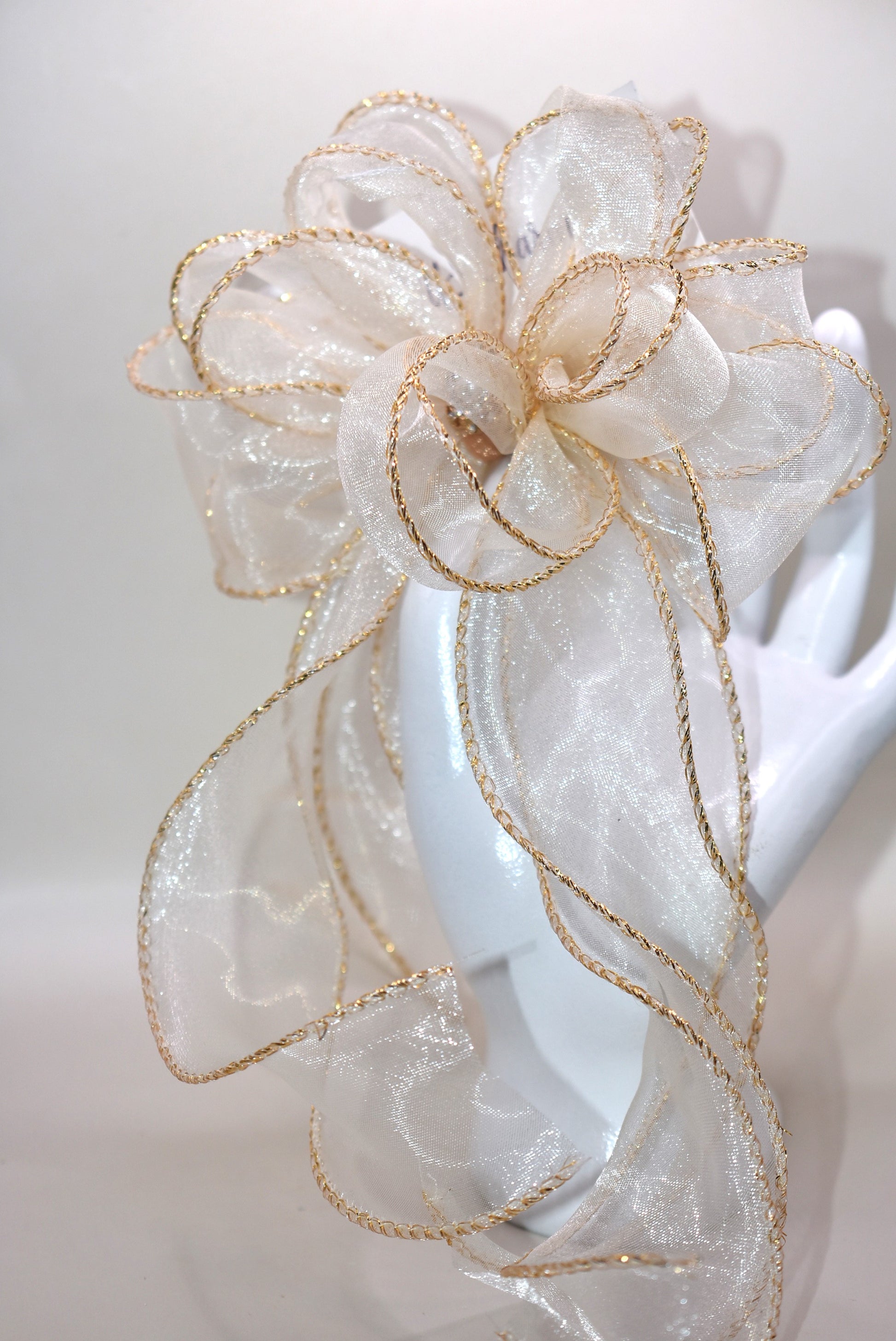 Elevate your ensemble with the Long Tail Collection bow, featuring elegant gold fish tail edging and a stunning gold gem accent. This refined accessory is perfect for any special occasion and suits all ages with its timeless appeal. The alligator-wrapped clip ensures a secure and comfortable fit, adding a subtle touch of sophistication to your look.