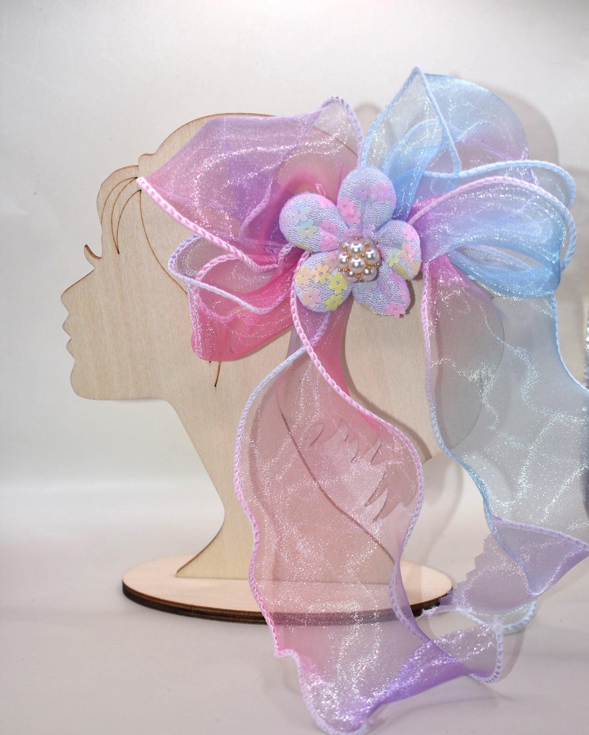 Brighten your style with the Long Tail Collection 2 bow! 🌈 This playful accessory features a colorful sheer ribbon topped with a charming fabric piece and a delicate pearl charm for that perfect touch of sparkle ✨. The wrapped alligator clip on the back ensures a secure fit for all-day wear. Add a pop of fun and elegance to any outfit! 🎀🐚
