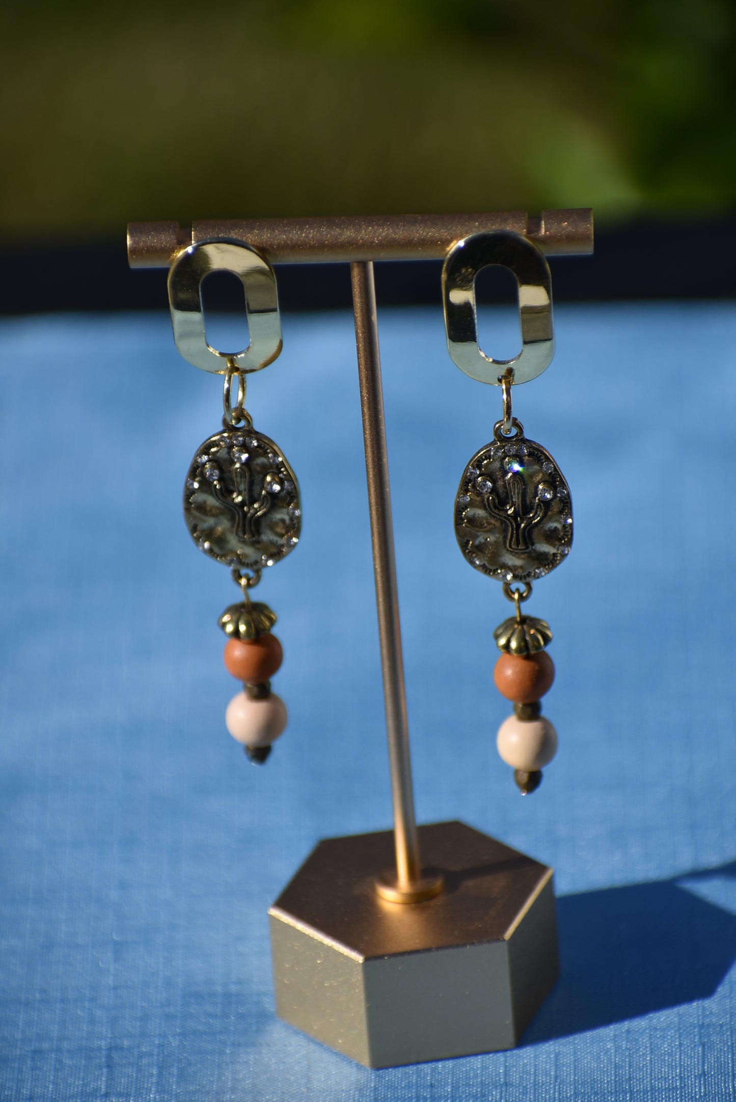 Don these wild West inspired earrings and make a fashion statement worth yodeling about! The open oblong silver posts sweetly support a cactus and crystal charm accompanied by multi-colored wood beads. Comfortable and lightweight, they hang on the long side, but will fill your ears with an unforgettable style. Whoa, Cowboy!