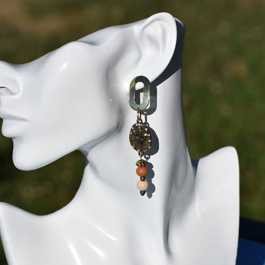 Don these wild West inspired earrings and make a fashion statement worth yodeling about! The open oblong silver posts sweetly support a cactus and crystal charm accompanied by multi-colored wood beads. Comfortable and lightweight, they hang on the long side, but will fill your ears with an unforgettable style. Whoa, Cowboy!