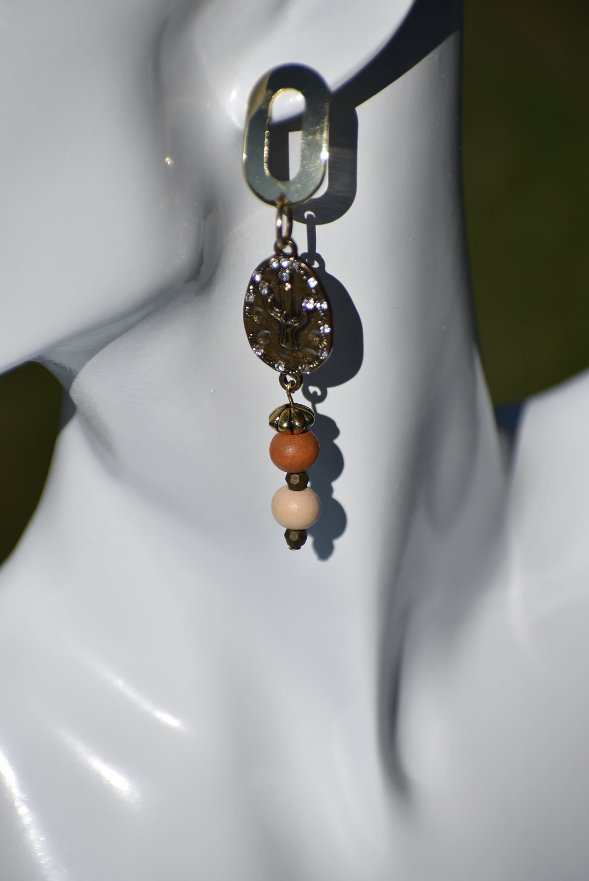 Don these wild West inspired earrings and make a fashion statement worth yodeling about! The open oblong silver posts sweetly support a cactus and crystal charm accompanied by multi-colored wood beads. Comfortable and lightweight, they hang on the long side, but will fill your ears with an unforgettable style. Whoa, Cowboy!