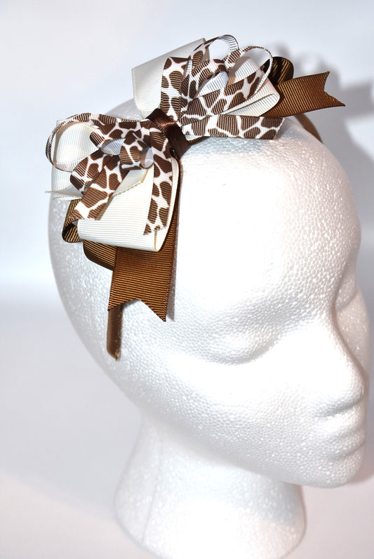 Bring a touch of whimsy to your look with this adorable cow print ribbon headband from Nana's Headband Collection. Featuring a charming brown and cream color combo on a thin satin cocoa brown band, it's as comfy as it is cute—perfect for all-day wear with a playful twist!