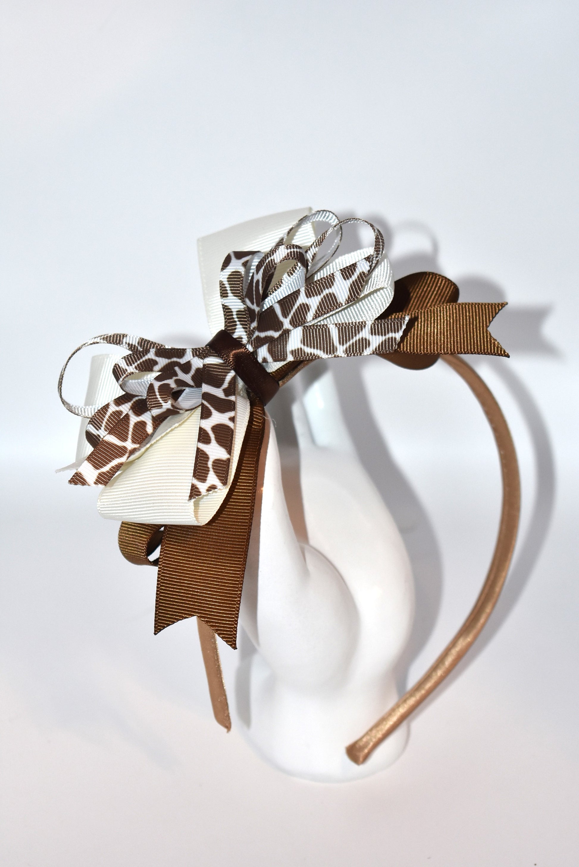 Bring a touch of whimsy to your look with this adorable cow print ribbon headband from Nana's Headband Collection. Featuring a charming brown and cream color combo on a thin satin cocoa brown band, it's as comfy as it is cute—perfect for all-day wear with a playful twist!
